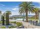 Relaxing community pool area with lounge chairs, palm trees, and mountain views at 44 Alta Cascata Pl, Henderson, NV 89011