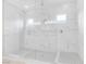 Luxury shower with marble tile, glass surround, dual shower heads and built-in shower niches at 44 Alta Cascata Pl, Henderson, NV 89011
