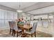 Elegant dining room featuring a large table, comfortable seating, and stylish chandelier, open to the kitchen at 480 Heritage Bridge Ave, Henderson, NV 89011