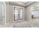Welcoming foyer with decorative glass doors, tile flooring, and elegant details with view to dining room at 480 Heritage Bridge Ave, Henderson, NV 89011