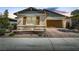 Charming single-story home with a well-maintained front yard and a two-car garage with brick paver driveway at 480 Heritage Bridge Ave, Henderson, NV 89011
