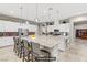 Modern kitchen featuring a large island with bar seating, stainless steel appliances, and stylish pendant lights at 480 Heritage Bridge Ave, Henderson, NV 89011