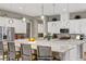 Modern kitchen with stainless steel appliances, granite countertops, and a large island with pendant lighting at 480 Heritage Bridge Ave, Henderson, NV 89011