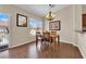 Cozy dining room with modern light fixture, view of outside, and hardwood floors at 5000 Red Rock St # 259, Las Vegas, NV 89118