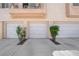 View of three single-car garages, featuring white doors and well-maintained landscaping, offering convenient parking at 5000 Red Rock St # 259, Las Vegas, NV 89118