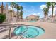 Inviting community hot tub with a view of the pool and surrounding palm trees for relaxation at 5000 Red Rock St # 259, Las Vegas, NV 89118