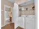Functional laundry room with modern washer and dryer and convenient storage shelves at 5000 Red Rock St # 259, Las Vegas, NV 89118