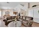 Open concept living room with dining area, hardwood floors and comfortable leather couch at 5000 Red Rock St # 259, Las Vegas, NV 89118
