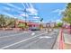 Community entrance with a security gate, mature trees, and well-maintained landscaping at 5021 River Glen Dr # 45, Las Vegas, NV 89103