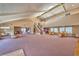 Spacious living room with high ceilings, natural light, carpet and dining tables near the kitchen at 5021 River Glen Dr # 45, Las Vegas, NV 89103