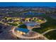 Night aerial view showcases community park with walking paths, picnic areas, and scenic lake at 516 Red Lovebird Ave # Lot 1242, Henderson, NV 89011