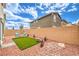 A well-maintained backyard with an outdoor seating area and artificial turf at 516 Red Lovebird Ave # Lot 1242, Henderson, NV 89011