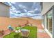 Cozy backyard with a small artificial grass patch, rock landscaping, and outdoor seating at 516 Red Lovebird Ave # Lot 1242, Henderson, NV 89011