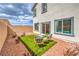 Inviting backyard features artificial grass, rock landscaping, and outdoor seating with a view of the house at 516 Red Lovebird Ave # Lot 1242, Henderson, NV 89011