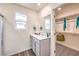 Well-lit bathroom offers single vanity, walk-in closet, modern fixtures, and wood-look floors for a sleek design at 516 Red Lovebird Ave # Lot 1242, Henderson, NV 89011
