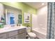 Inviting bathroom with green walls, modern vanity, tub, and decorative shower curtain at 516 Red Lovebird Ave # Lot 1242, Henderson, NV 89011