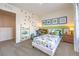 Bright bedroom with dinosaur theme decor, modern desk, and bookshelf, creating a playful space at 516 Red Lovebird Ave # Lot 1242, Henderson, NV 89011