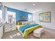 Bright bedroom featuring a blue accent wall, plush bedding, and ample natural light from two large windows at 516 Red Lovebird Ave # Lot 1242, Henderson, NV 89011