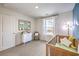 This delightful Bedroom has a wooden crib, stylish decor, and a serene atmosphere by the window at 516 Red Lovebird Ave # Lot 1242, Henderson, NV 89011