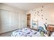 Well-lit bedroom features closet, bookshelf, dinosaur themed decor, and modern desk in a playful design at 516 Red Lovebird Ave # Lot 1242, Henderson, NV 89011