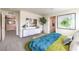 Bright bedroom boasts a TV, decorative tree, walk-in closet, and colorful bedspread, exuding comfort and style at 516 Red Lovebird Ave # Lot 1242, Henderson, NV 89011