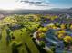 Birds-eye view of a community park with playground, picnic areas, lush landscaping and walking paths at 516 Red Lovebird Ave # Lot 1242, Henderson, NV 89011