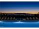 A beautifully lit, inviting community pool with lounge chairs, providing a resort-like experience for residents at 516 Red Lovebird Ave # Lot 1242, Henderson, NV 89011