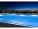 A full view of a pristine community pool, complete with lounge chairs, offering a relaxing oasis for residents at 516 Red Lovebird Ave # Lot 1242, Henderson, NV 89011
