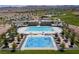 Resort-style community pool with lounge chairs, splash pad, picnic tables, and well-maintained landscaping at 516 Red Lovebird Ave # Lot 1242, Henderson, NV 89011