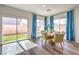 Dining area with backyard access through sliding glass doors, complemented by contemporary furnishings and bright natural light at 516 Red Lovebird Ave # Lot 1242, Henderson, NV 89011