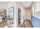 Welcoming entryway featuring wood-look floors and an accent wall, leading to a powder room and kitchen at 516 Red Lovebird Ave # Lot 1242, Henderson, NV 89011
