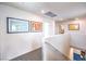 Upstairs hallway featuring modern artwork, neutral walls, and views into adjacent rooms at 516 Red Lovebird Ave # Lot 1242, Henderson, NV 89011
