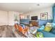 Bright living room with trendy decor, including stylish furniture, modern art, and wood-look flooring at 516 Red Lovebird Ave # Lot 1242, Henderson, NV 89011
