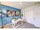 Bright home office with a blue accent wall, white desk, and contemporary artwork at 516 Red Lovebird Ave # Lot 1242, Henderson, NV 89011