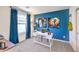 Stylish office features a sleek white desk, bold blue wall, and modern decor at 516 Red Lovebird Ave # Lot 1242, Henderson, NV 89011