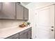 Walk-in pantry with quartz countertop, gray cabinets, and shelving for ample storage space at 516 Red Lovebird Ave # Lot 1242, Henderson, NV 89011