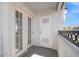 Cozy outdoor balcony featuring white stucco and a black metal railing, accessed by French doors at 5201 S Torrey Pines Dr # 1221, Las Vegas, NV 89118
