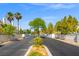 Scenic entrance to a gated community with manicured landscaping, and palm trees at 5201 S Torrey Pines Dr # 1221, Las Vegas, NV 89118