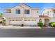 Charming townhome featuring white stucco, red tile roof, and spacious two-car garages at 5201 S Torrey Pines Dr # 1221, Las Vegas, NV 89118