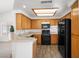 Kitchen showcasing wood cabinets, modern appliances, and new flooring at 5201 S Torrey Pines Dr # 1221, Las Vegas, NV 89118