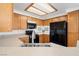 Well-lit kitchen with wood cabinets, black appliances, and laminate countertops at 5201 S Torrey Pines Dr # 1221, Las Vegas, NV 89118
