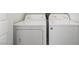 Convenient laundry area featuring a modern, stacked, white washer and dryer at 5201 S Torrey Pines Dr # 1221, Las Vegas, NV 89118