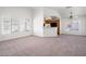 Bright open-concept living space with carpet flooring, modern ceiling fan, and large windows at 5201 S Torrey Pines Dr # 1221, Las Vegas, NV 89118