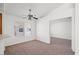 Sunlit living room featuring a ceiling fan and neutral carpet at 5201 S Torrey Pines Dr # 1221, Las Vegas, NV 89118