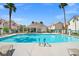 Community pool offers a refreshing escape with seating and shade under swaying palm trees at 5201 S Torrey Pines Dr # 1221, Las Vegas, NV 89118