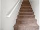 Carpeted staircase featuring a white handrail and a neutral wall color at 5201 S Torrey Pines Dr # 1221, Las Vegas, NV 89118