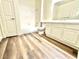 Well-lit bathroom featuring a vanity, tub, shower, and wood-look flooring at 5250 S Rainbow Blvd # 2029, Las Vegas, NV 89118