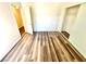 Bright bedroom with wood-look flooring, closet, and access to hallway at 5250 S Rainbow Blvd # 2029, Las Vegas, NV 89118