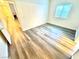 Bright bedroom features neutral walls, wood-look flooring, window, and access to the hallway at 5250 S Rainbow Blvd # 2029, Las Vegas, NV 89118