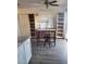 A dining area with laminate floors, display cabinets, and a table near the sliding glass doors at 5335 Rod Ct # 102, Las Vegas, NV 89122